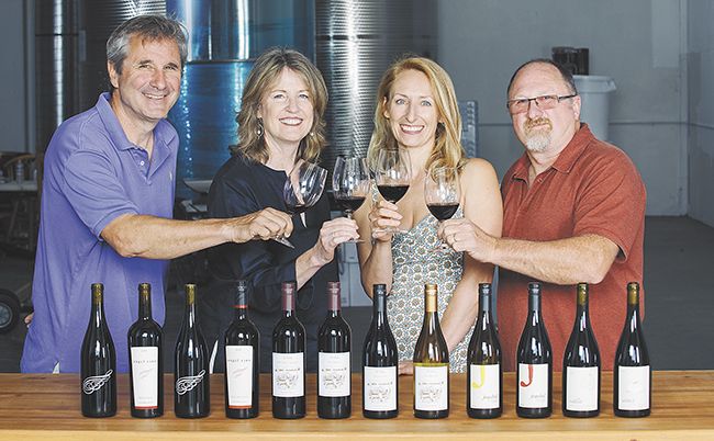 Ed Fus, Laureen O’Brien, Pam Walden and Joe Williams toast Urban Crush, the newly opened shared winemaking space in Southeast Portland.##Photo by Kathryn Elsesser
