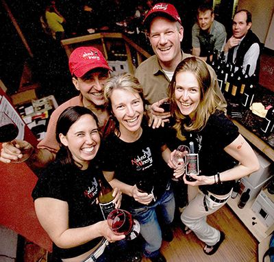 Founders David Barringer (red hat), his wife, Jody (front center) and Dave Michalec (right rear) with Hood River tasting room servers on opening  day.##Photo provided