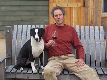 Alexis Pouillon and his dog, T-Bone, relax in front of Domaine Pouillon.