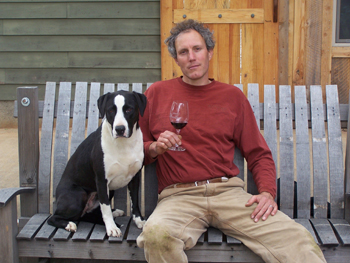 Alexis Pouillon and his dog, T-Bone, relax in front of Domaine Pouillon.