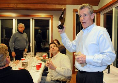 At one of his monthly blind tastings, Peter Adesman reveals a wine to his fellow oenophiles, including Ron Rezek (standing) and Paul
Jorizzo (sitting).