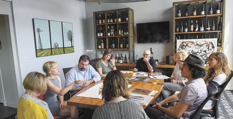 The student artists meet with Chris Cullina and Argyle’s label designers and printers to collaborate on how to convert the original art pieces into actual wine labels. ##Photo by Andrea Johnson