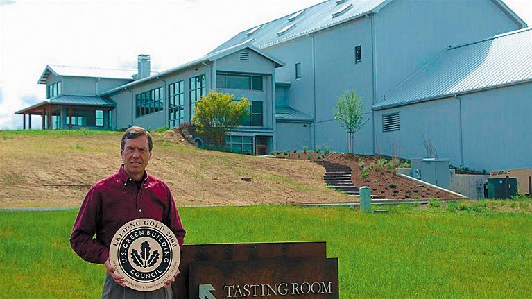 Bill Stoller holding the LEED Gold Certification plaque for the winery building behind him. ## Photo provided by Stoller Wine Group Bill Stoller holding the LEED Gold Certification plaque for the winery building behind him. ## Photo provided by Stoller Wine Group