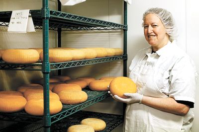 Sarah Marcus holds a wheel of Iris, a washed-rind goat cheese.