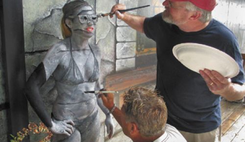 John Stromme (right) and Eddie Johnson paint Youngberg Hill assistant winemaker Ariel Eberle to look like the mural behind her at the McMinnville winery.