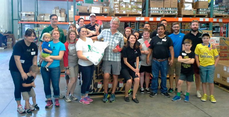 Employees of A to Z Wineworks of Newberg, including co-owners Bill Hatcher and Sam Tannahill, volunteer at the food bank at YCAP (Yamhill Community Action Partnership). Charity work is part of the B Corp standards. ##Photo provided