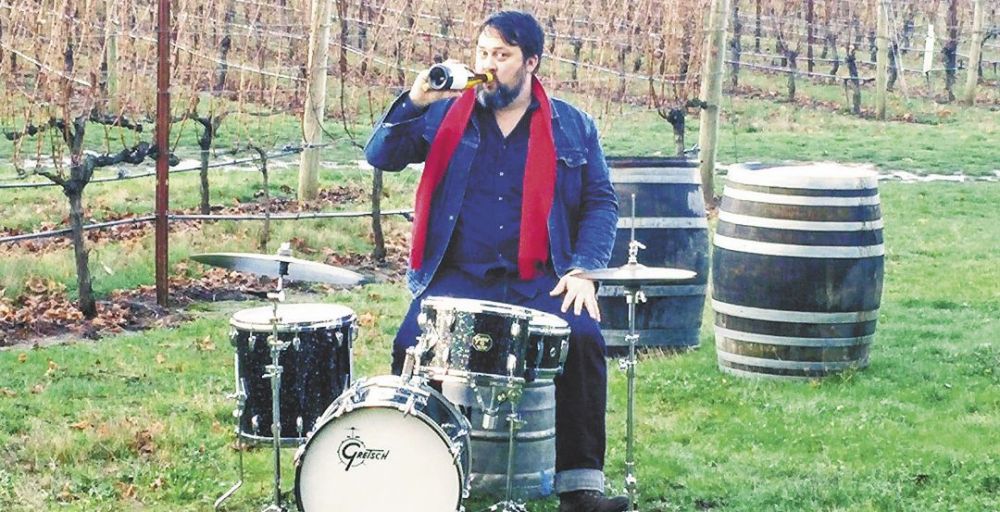 Andy Young multitasking in the vineyard. ##Photo by Michael Alberty