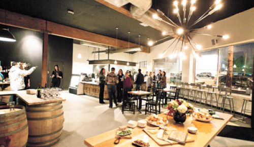 During the grand opening of Cyril’s at Clay Pigeon Winery in Southeast Portland, guests sample food and enjoy glasses of wine.