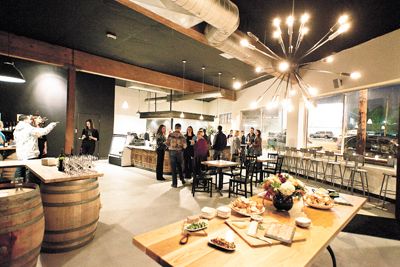 During the grand opening of Cyril’s at Clay Pigeon Winery in Southeast Portland, guests sample food and enjoy glasses of wine.