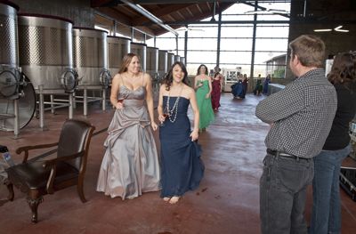 Erica Landon(left) and Jennifer Cossey, followed by Carrie Stigge and the rest of the sommeliers, feel the chill of the fermentation room at Soléna & Grand Cru Estates. Winemaker Bruno Corneaux and OWP editor Hilary Berg watch as they enter.  Photo by Andrea Johnson