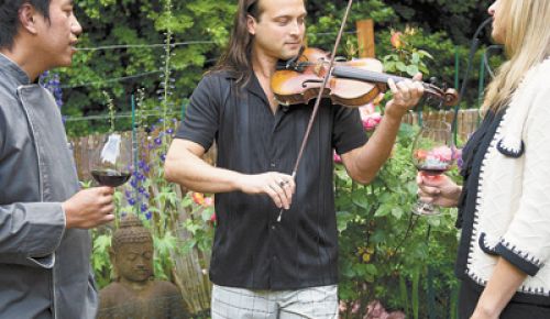 In his home garden in Portland, Aaron Meyer entertains guests, including his wife, Renée, and celebrity Thai chef Sonthaya Kaewpradit (Surin Beach Hotel
in Phuket). Photo by Andrea Johnson