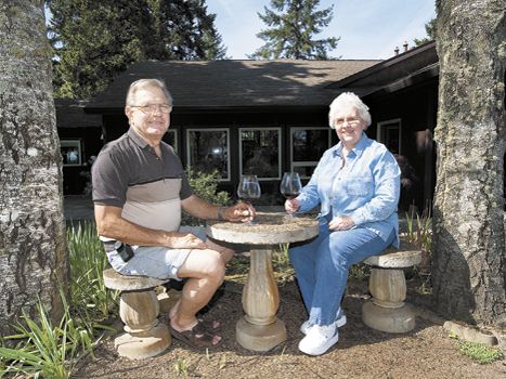 Joe and Shari Lobenstein share a bottle of Oregon wine at their B&B located outside of Carlton. Photo by Marcus Larson.