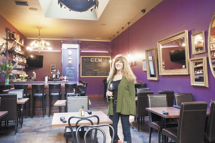 Kathy Stoler, owner of Gem Creole Saloon, stands amid the restaurant’s jazzed up interior. Photo by Marcus Larson