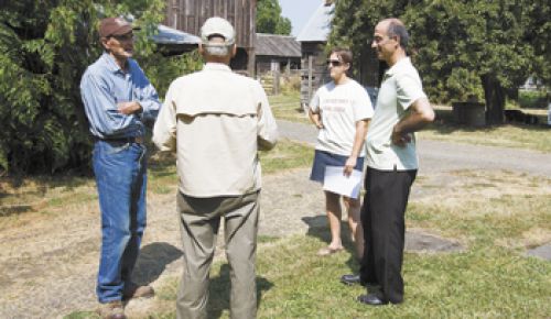 Farmer Charlie Chegwyn, left, talks with a farm visitor, Kamal Kotaich and Marie Vicksta of the Soil & Water Conservation District on a recent tour of historic Chegwyn Farms.  Photo by Marcus Larson