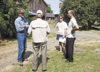 Farmer Charlie Chegwyn, left, talks with a farm visitor, Kamal Kotaich and Marie Vicksta of the Soil & Water Conservation District on a recent tour of historic Chegwyn Farms.  Photo by Marcus Larson