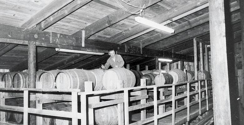 Richard Sommer tends to barrels in the early years at HillCrest Vineyard. Although he died in 2009, his memory lives on through the winery he founded and his wine industry legacy. ##Photo courtesy of LInfield College Archives