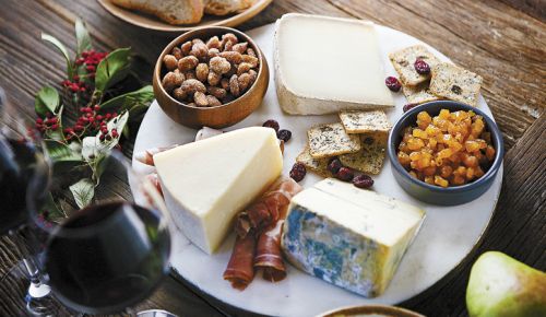 Alongside seed crackers, cured meats, almonds and dried fruit, a trio of cheeses are on display: Face 2 Face (left); Secret de Compostelle (top); Chiriboga Blue (bottom right). ##Photo by Christine Hyatt