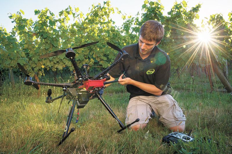 Stephen Burtt, co-founder of Aerial Technology International, readies his ATI hexacopter with MicaSense RedEdge sensors for a fly over Carlo & Julian Vineyard near Carlton to gather multispectral imaging for analysis. ##Photo by Andrea Johnson