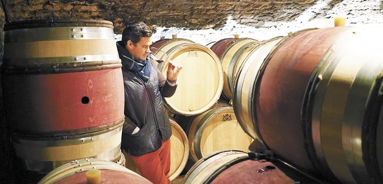 Louis-Michel Liger-Belair samples wine from the barrels of his family’s winery, Domaine du Comte Liger-Belair. ##Photo by Steen Öhman/Winehog.org