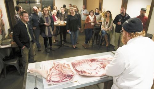 Chef Red Hauge demonstrates butchering a pig prior to a dinner centered on seasonal ingredients. ##Photo by Rockne Roll