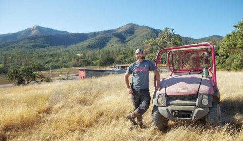 Herb Quady, the Oregon Wine Press 2023 Person of the Year, standing next to the Mule, a 2004 Kawasaki that continues to run great.##Photo By John Valis, courtesy of the Oregon Wine Board