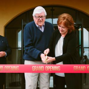 Culinary icon Emeril Lagasse watches as owners Ken and Grace Evenstad cut the ribbon of The Clubhouse at Domaine Serene, a 34,000-square-foot event facility on the winery’s estate vineyard. ##Photo Courtesy of Domaine Serene Culinary icon Emeril Lagasse watches as owners Ken and Grace Evenstad cut the ribbon of The Clubhouse at Domaine Serene, a 34,000-square-foot event facility on the winery’s estate vineyard. ##Photo Courtesy of Domaine Serene
