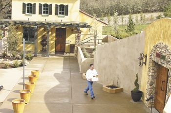 Dan Marca moves a case of wine to DANCIN Vineyards’ cave for storage.