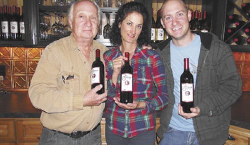 David (left), Sandy and Leon Glaser proudly hold their new wine for sale at their tasting room in Roseburg. Photo provided.