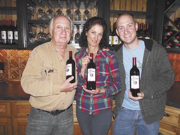David (left), Sandy and Leon Glaser proudly hold their new wine for sale at their tasting room in Roseburg. Photo provided.