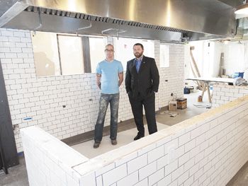 Paulée owners, Executive Chef daniel Mondok (left) and Sommelier Brandon tebbe, stand in what will be dundee’s newest upscale restaurant, set to open in May.