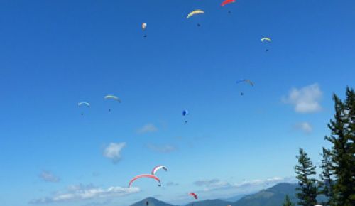 Participants in last year’s paragliding competition get ready to launch off Woodrat Mountain, only two miles from Fiasco Winery, near Jacksonville.