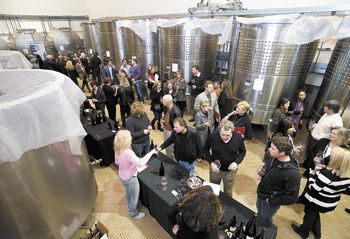 Of the 42 wineries pouring their 2010 ¡Salud! cuvée Pinot Noirs during the annual barrel auction at Domaine Drouhin Oregon, 18 were stationed on the main fermentation floor. Photo by Marcus Larson/News-Register