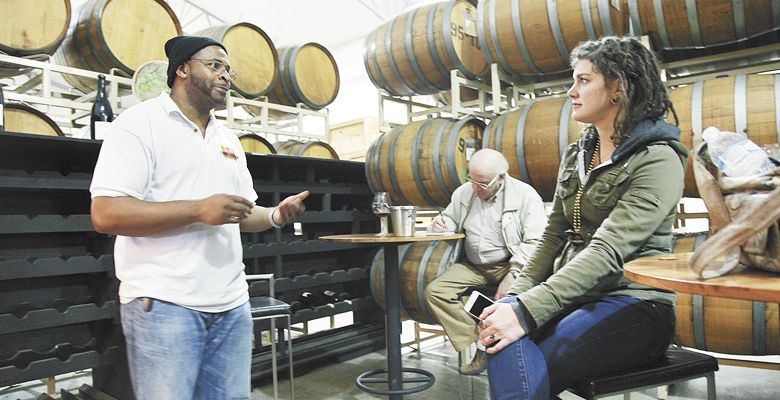 Marcus Horne, owner of Homegrown Weed & Wine Tours, chats with a participant at Duck Pond Cellars in Dundee. ##Photo by Nick Taylor