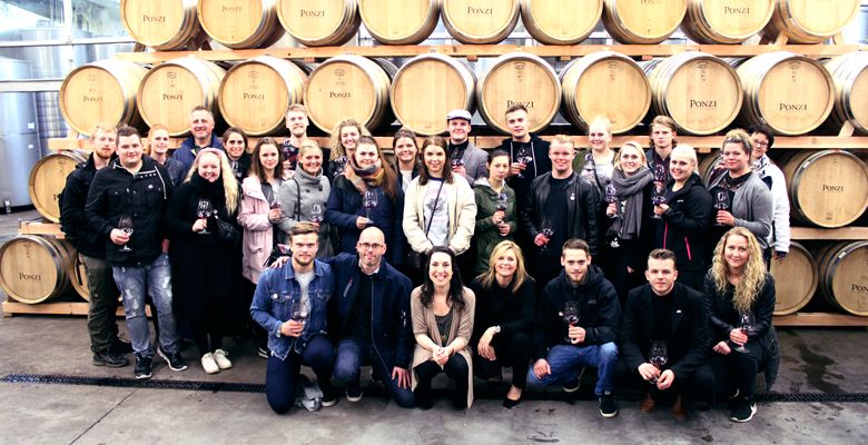 Danish students and staff receive a tour of the Ponzi barrel room. ##Photo courtesy of Ponzi Vineyards