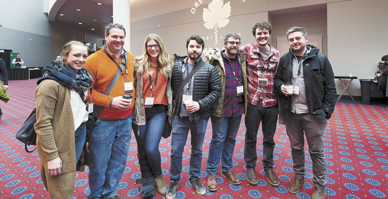 . Friends and colleagues meet in the lobby: (from left) Meagan Yount and Jeff Katz of Carlton Winemakers Studio; Kimberly Abrahams of Lingua Franca; Sean Vroomen of Adelsheim; Andrew Kirkland of Ruby Vineyard; James Braunagel of Lemelson; and Thomas Savre of Lingua Franca. ##Photos by Carolyn Wells-Kramer