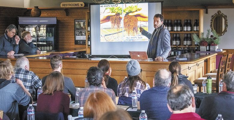 During a pre-conference gathering at Montinore Estate before the 2018 International Biodynamic Conference in Portland, Italian Biodynamic consultant Adriano Zago compares roots in soil farmed Biodynamically versus conventionally. ##Photo by Andrea Johnson