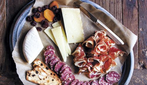 Slices of fennel salami, from Chop in Portland, and coppa rosettes, from The Beautiful Pig in Longview, Washington, accompany six-month aged Manchego and sheep’s milk Robiola. ##Photo by Christine Hyatt