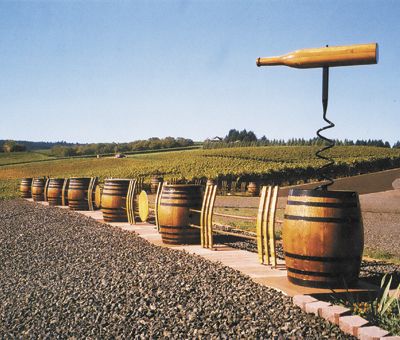 Wine barrels, a massive cork screw and barrel staves create a dramatic fence line adjacent to Sims Estate Vineyard at Barrel Fence Cellars in Dundee.