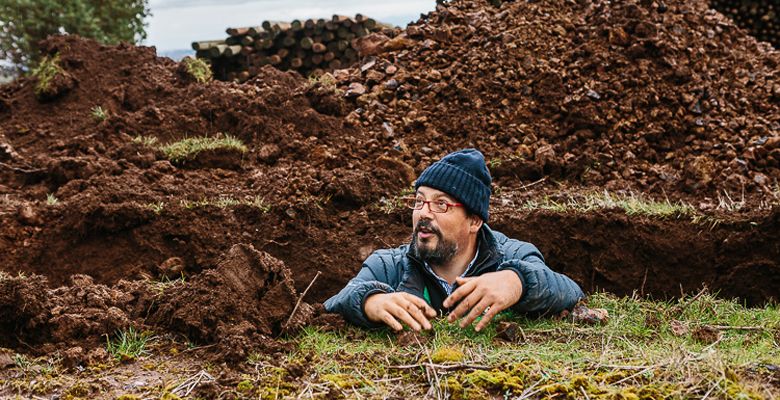 Terroir expert Pedro Parra stands in a trench, where he gathers soil samples. ##Photo by Kimberly Hasselbrink