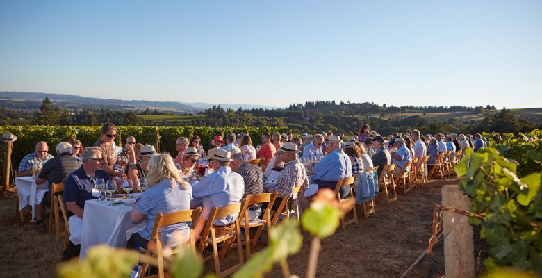 Guests enjoy a dinner in the vineyard during one of the 30th anniversary events. ##Photo by Serge Chapuis