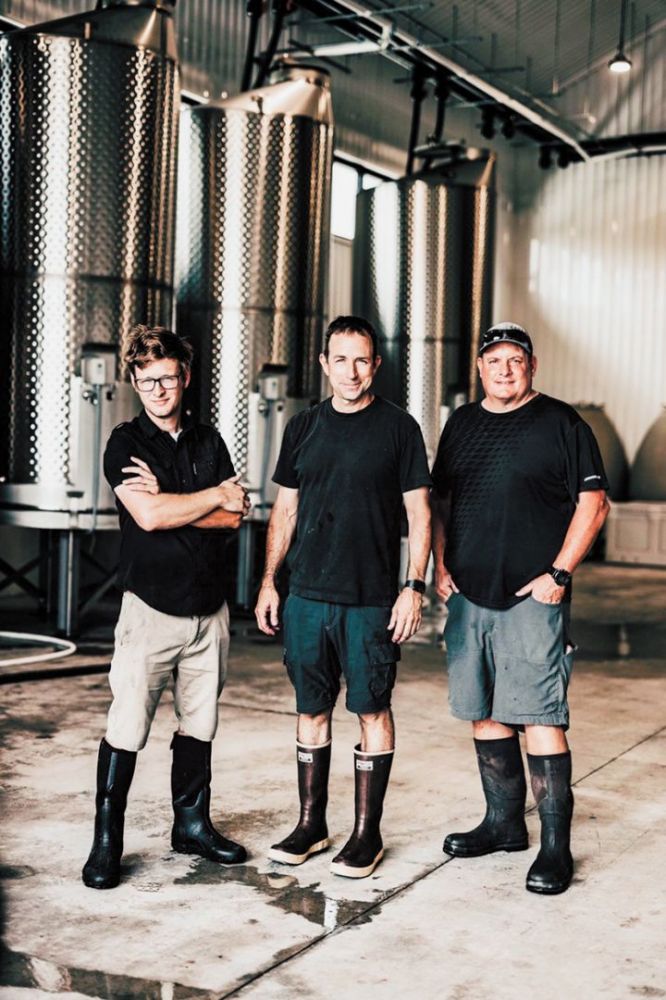 Eric Weisinger (center), in the winery with his crew.##Photo by Erica Falbaum