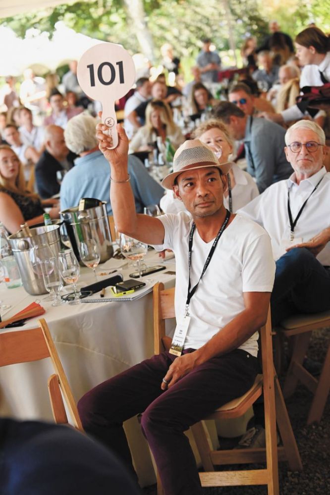 Ron Acierto, wine curator and beverage director at McMinnville’s okta restaurant, bids on exclusive auction wines. ##Photo by Carolyn Wells-Kramer