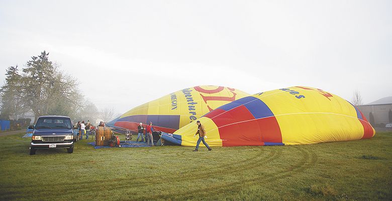 Industrial fans as well as propane tanks attached to the basket help fill the envelope.##Photo by Bryan Rupp