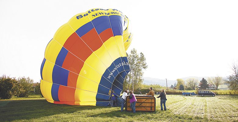 Volunteers meet the balloon where it lands, helping with the deflating of the envelope.##Photo by Bryan Rupp