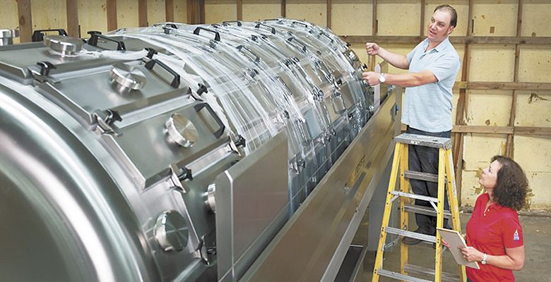 Naumes and Graves inspect the new press for the custom facility.##Photo courtesy of Naumes Custom Crush and Fermentation