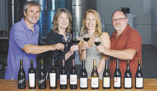 Ed Fus, Laureen O’Brien, Pam Walden and Joe Williams toast Urban Crush, the newly opened shared winemaking space in Southeast Portland.##Photo by Kathryn Elsesser