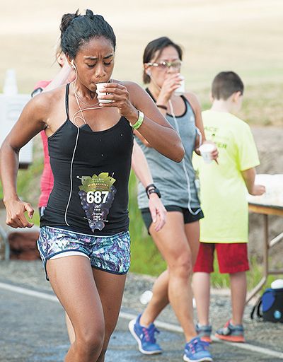Rockne Roll / News-Register##Runners stay hydrated during the Oregon Wine Country Half Marathon s 13.1-mile run through rolling hills. Rockne Roll / News-Register##Runners stay hydrated during the Oregon Wine Country Half Marathon s 13.1-mile run through rolling hills.