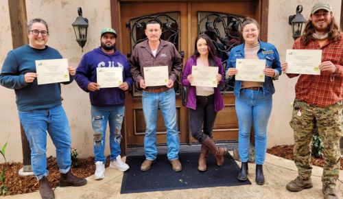 Troon team members with their diplomas after completing the Equitable Food Initiative training.##Photo PROVIDED