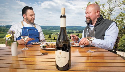King Estate’s Matt Hobbs, executive chef (left) and Brent Stone, winemaker and COO, dining on Beef Tartare, made at the winery restaurant, paired with King Estate 2018 Quail Run Viognier. ##PHOTO BY ANDY NELSON