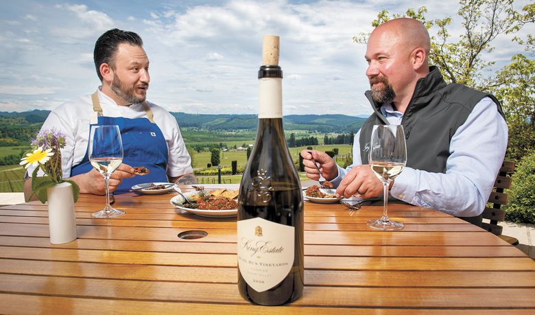 King Estate’s Matt Hobbs, executive chef (left) and Brent Stone, winemaker and COO, dining on Beef Tartare, made at the winery restaurant, paired with King Estate 2018 Quail Run Viognier. ##PHOTO BY ANDY NELSON